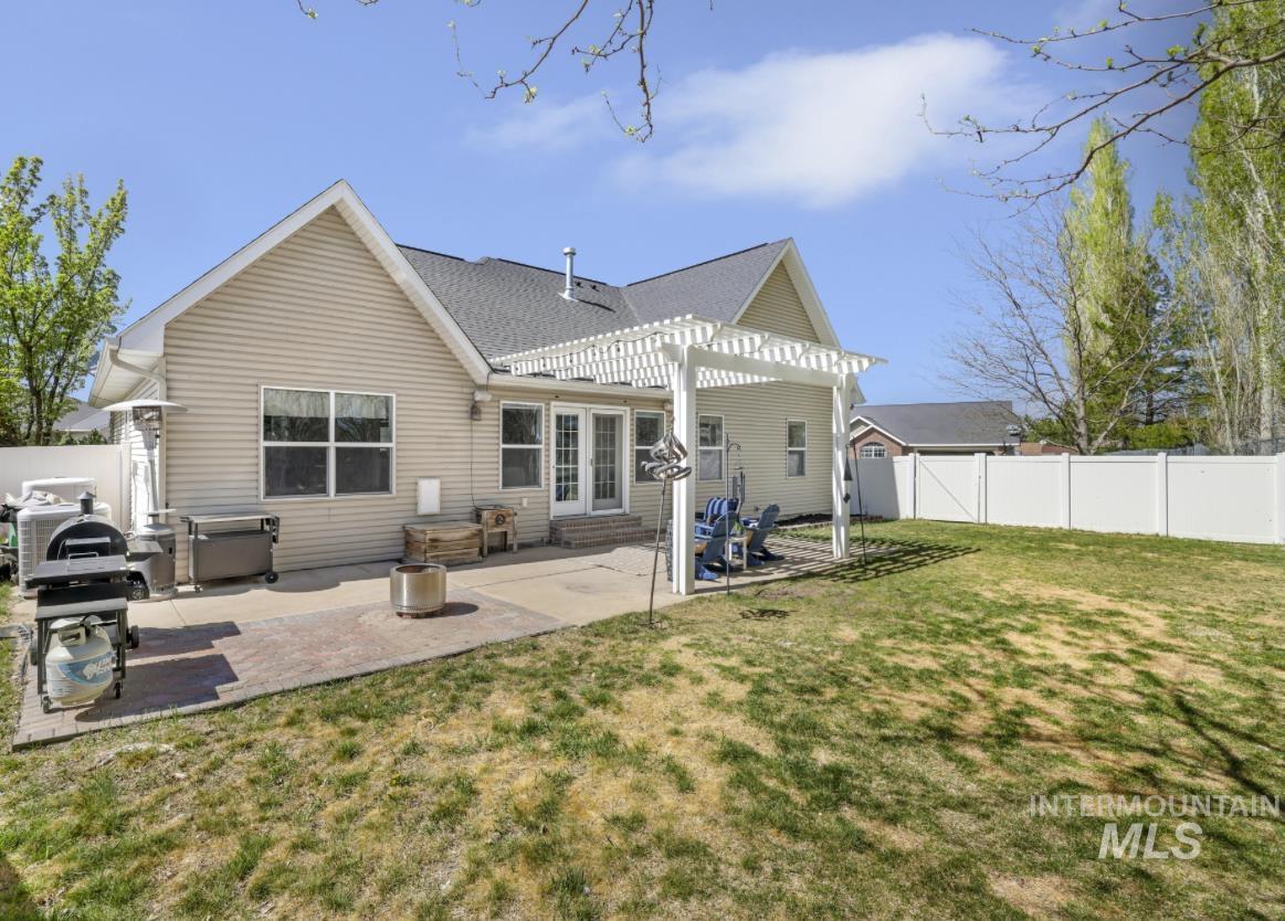 1111 Cole Street Kimberly, ID 83341 - Photo 42 of 46 Rear view of house featuring a pergola, a patio area, a fenced backyard, and a shingled roof