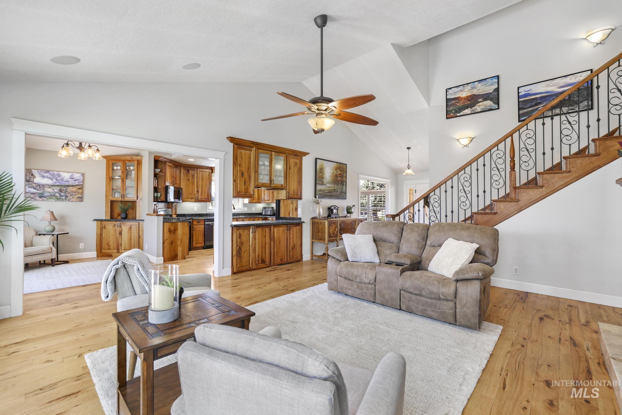 1111 Cole Street Kimberly, ID 83341 - Photo 6 of 46 Living room with light wood-style floors, suspended lighting, lofted ceiling, and ceiling fan
