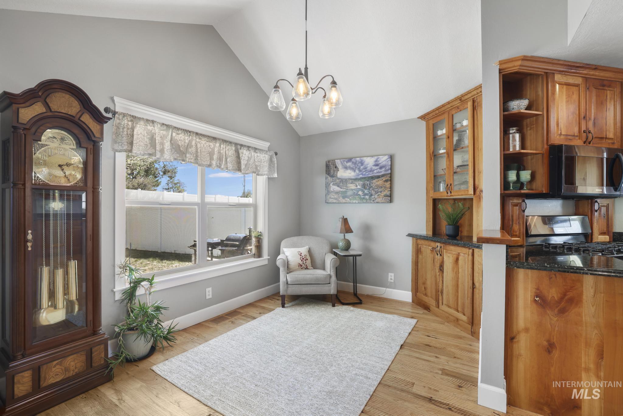 1111 Cole Street Kimberly, ID 83341 - Photo 7 of 46 Living area featuring lofted ceiling, a chandelier, and light wood-style flooring