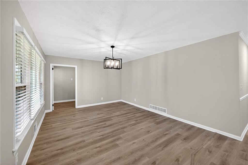 187 Old Timber Road Lawrenceville, GA 30046 - Photo 20 of 32 wooden floor in an empty room with a window