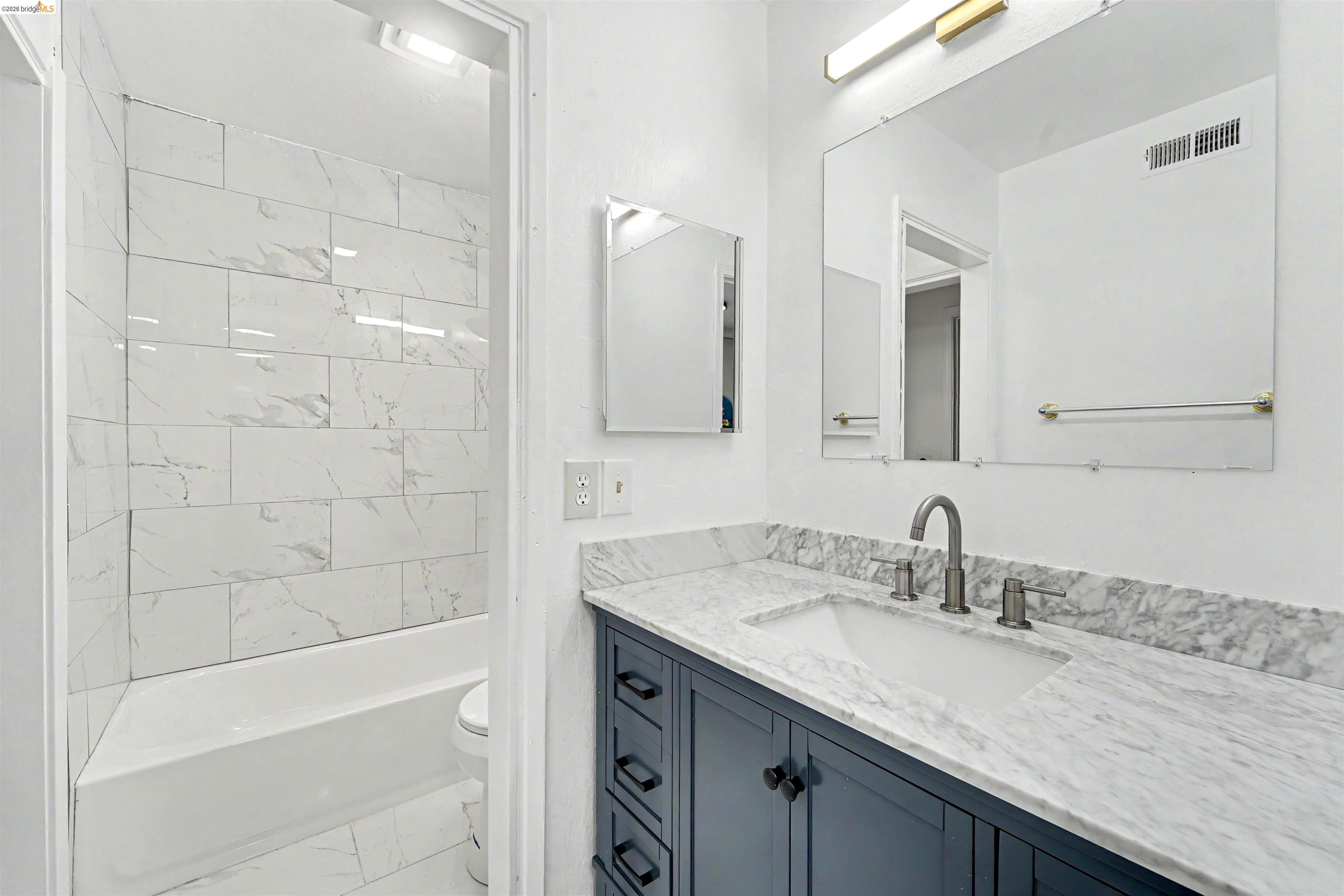 4186 San Pablo Dam Road, Unit A El Sobrante, CA 94803 - Photo 17 of 34 Bathroom vanity featuring a quartz countertop with integrated sink and brushed nickel faucet
