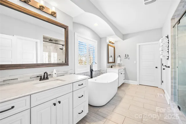 a view of walk in closet with clothes