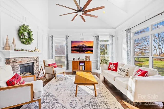 a kitchen with white cabinets and wooden floor