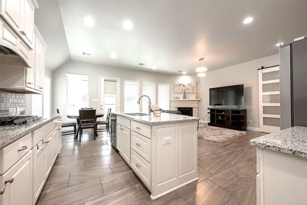 a large kitchen with stainless steel appliances kitchen island granite countertop a large counter top and sink