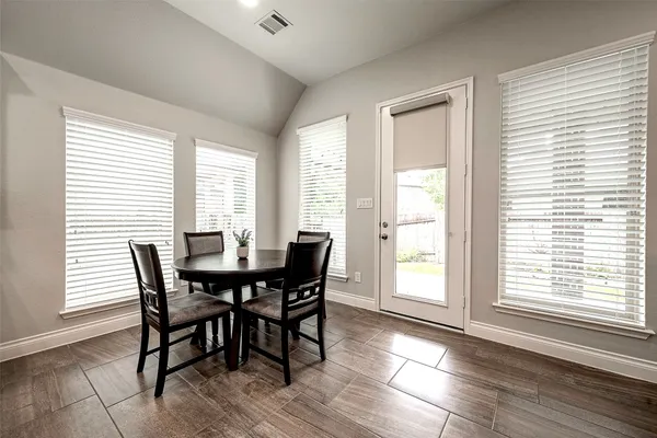 a view of a dining room with furniture and windows