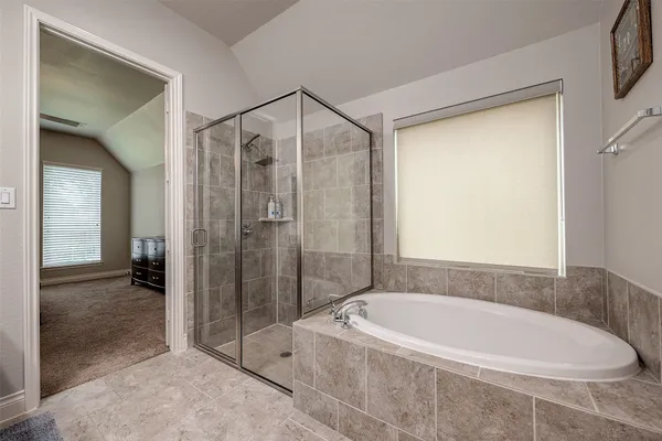a bathroom with a bathtub and a shower