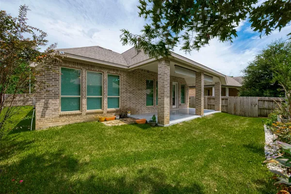 a view of a house with a yard and sitting area
