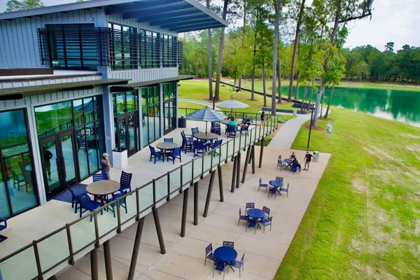 an outdoor sitting area with furniture and garden view