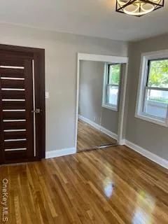 a view of an empty room with a fireplace and a window