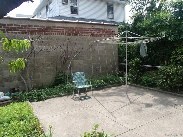 a view of a chair and table in backyard