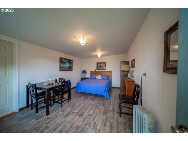 a kitchen with kitchen island a stove a table and chairs in it