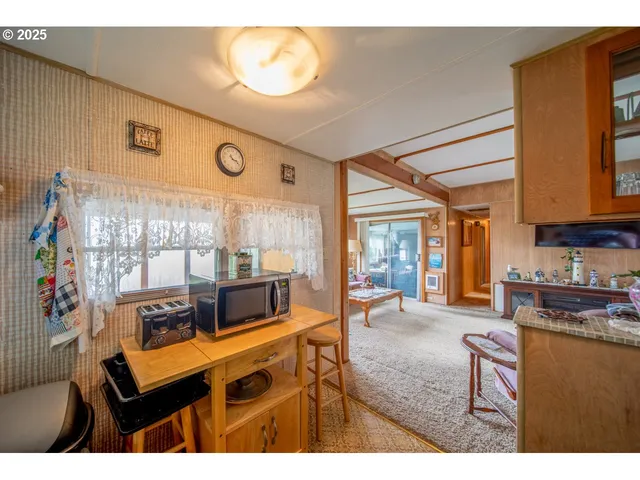 a living room with furniture a flat screen tv and a large window