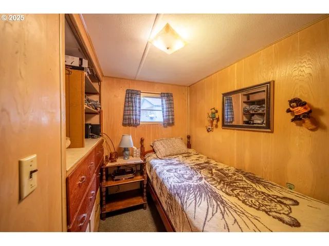 a view of a bedroom with a bed and a window