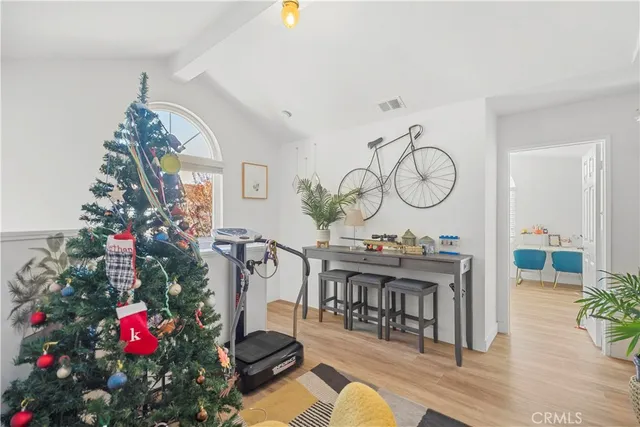 a living room with furniture a chandelier and a table