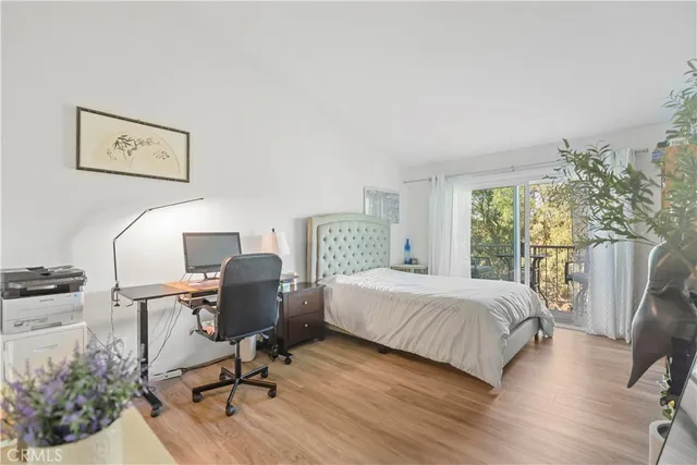 a bedroom with a bed chair and a window