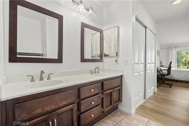 a bathroom with double sink and a mirror