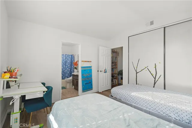 a bedroom with a bed and a desk