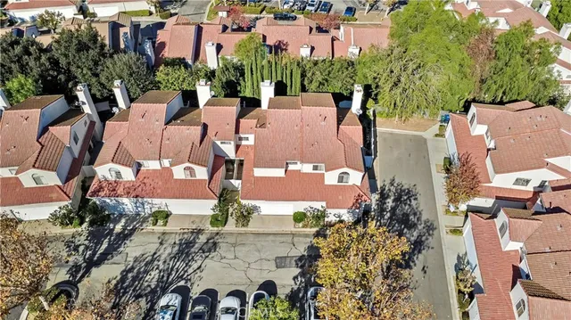 an aerial view of a house with a yard and garden