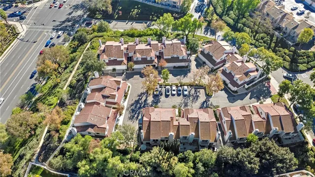 an aerial view of multiple houses with yard