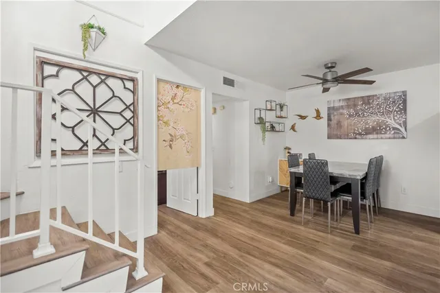 a view of a dining room with furniture and wooden floor
