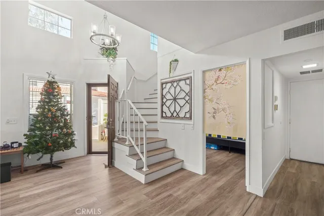 a view of entryway with stairs and wooden floor