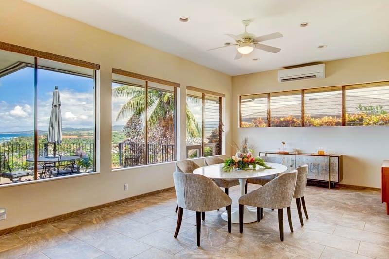 2301 Ho'ohu Road Koloa, HI 96756 - Photo 11 of 28 a dining room with furniture a chandelier and a large window