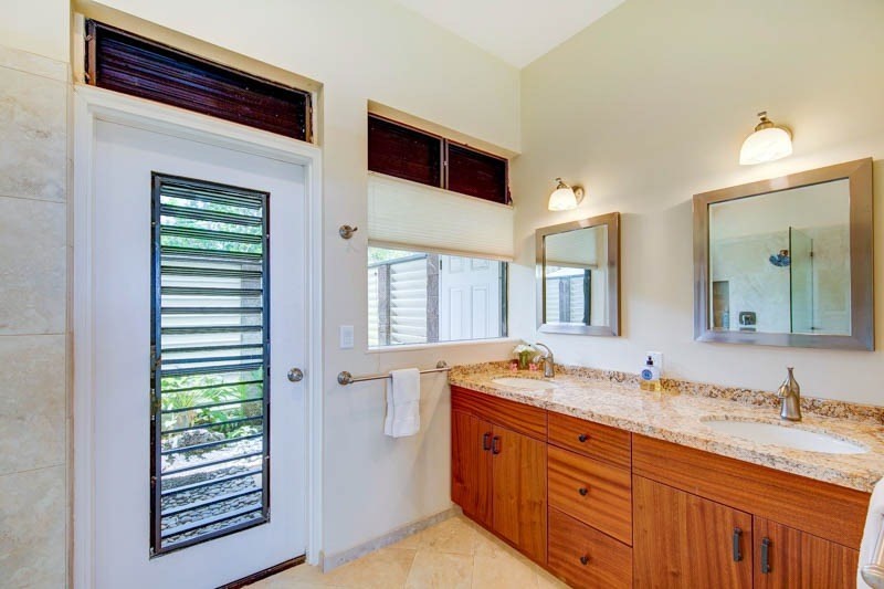 2301 Ho'ohu Road Koloa, HI 96756 - Photo 18 of 28 a bathroom with a granite countertop sink and a mirror
