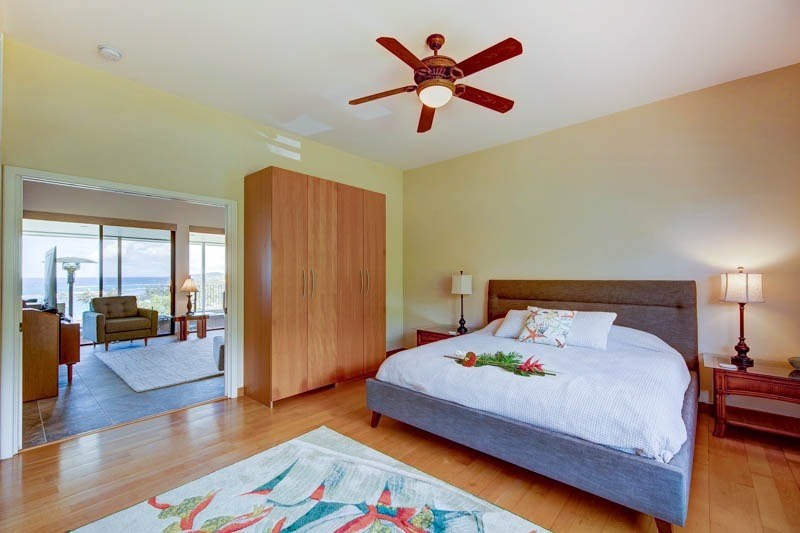 2301 Ho'ohu Road Koloa, HI 96756 - Photo 21 of 28 a bedroom with a bed and wooden floor