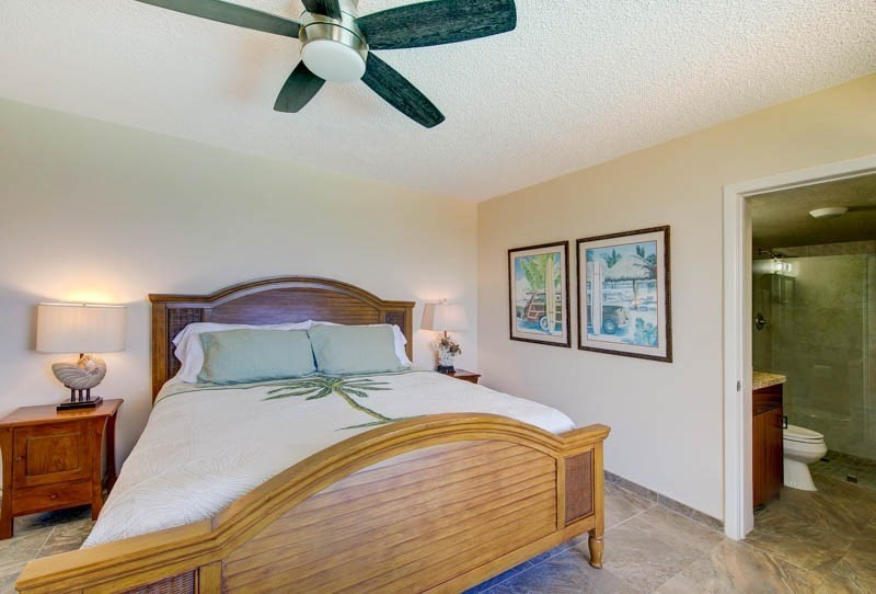 2301 Ho'ohu Road Koloa, HI 96756 - Photo 23 of 28 a bedroom with a bed and painting on the wall