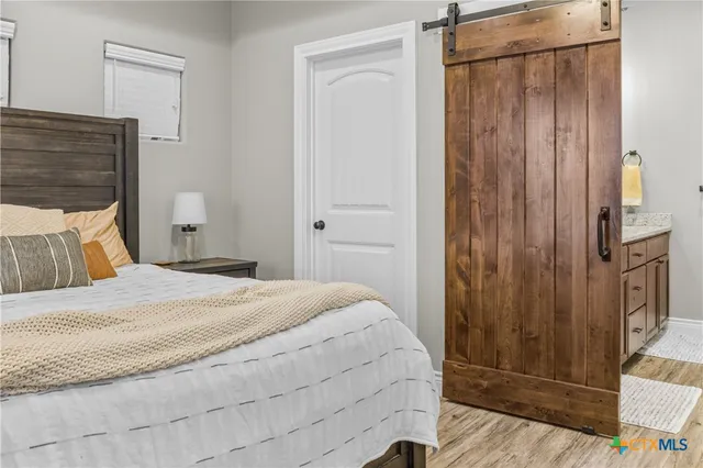 a bedroom with a bed and a mirror