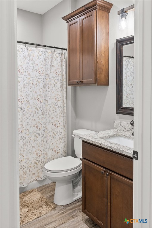 314 Blue Jay Loop Victoria, TX 77905 - Photo 18 of 27 a bathroom with a granite countertop sink a toilet and a mirror