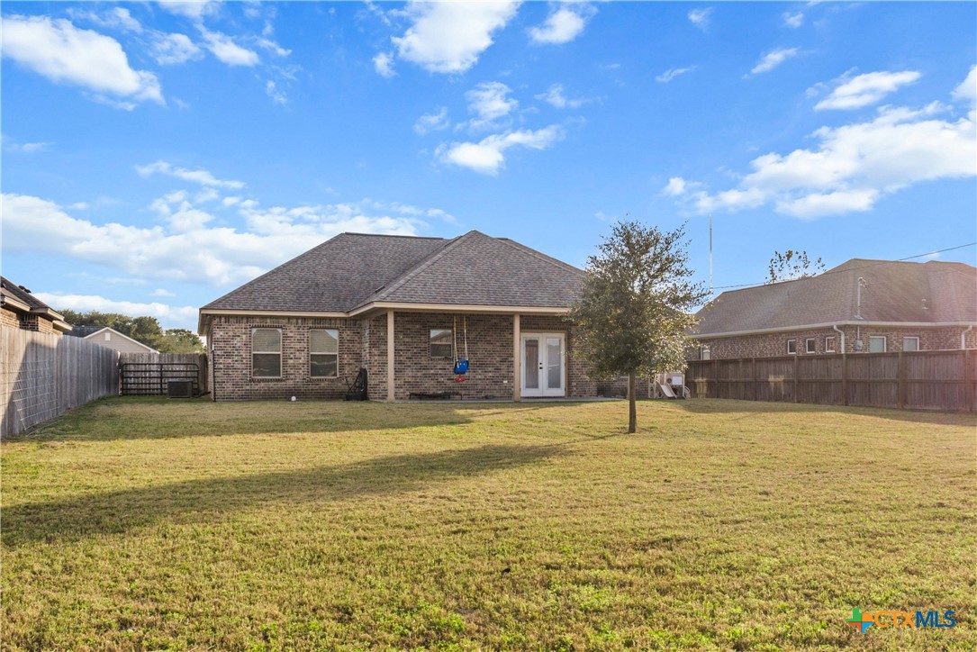 314 Blue Jay Loop Victoria, TX 77905 - Photo 24 of 27 a view of a large pool with a lawn chairs under an umbrella