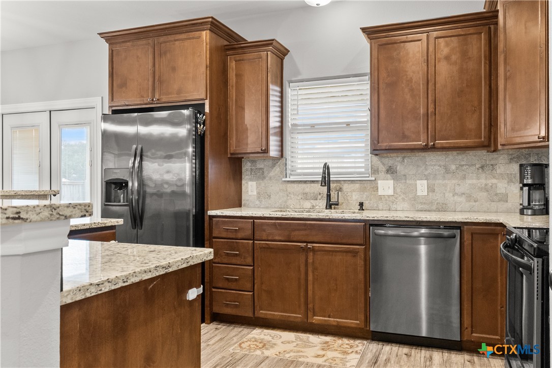 314 Blue Jay Loop Victoria, TX 77905 - Photo 9 of 27 a kitchen with stainless steel appliances granite countertop a sink stove and refrigerator