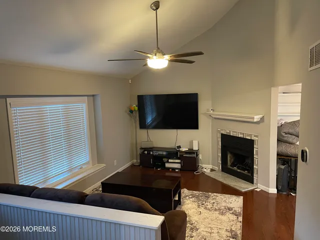a living room with furniture a fireplace and a flat screen tv