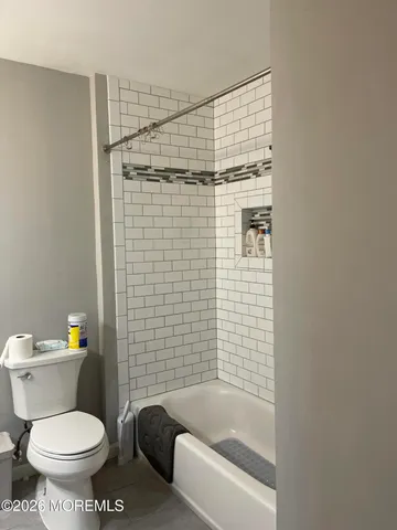 a bathroom with a toilet and shower