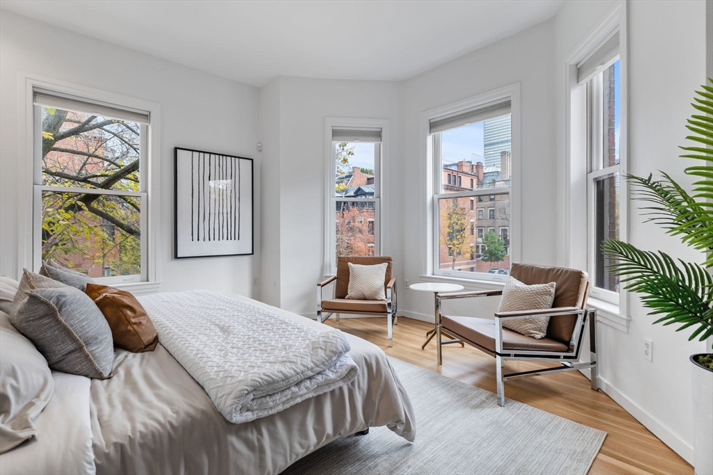 363 Marlborough Street, Unit 5 Boston, MA 02115 - Photo 11 of 23 a bedroom with a bed and large windows