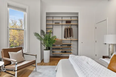 a bedroom with furniture and a potted plant
