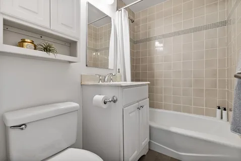 a bathroom with a sink a toilet and bathtub