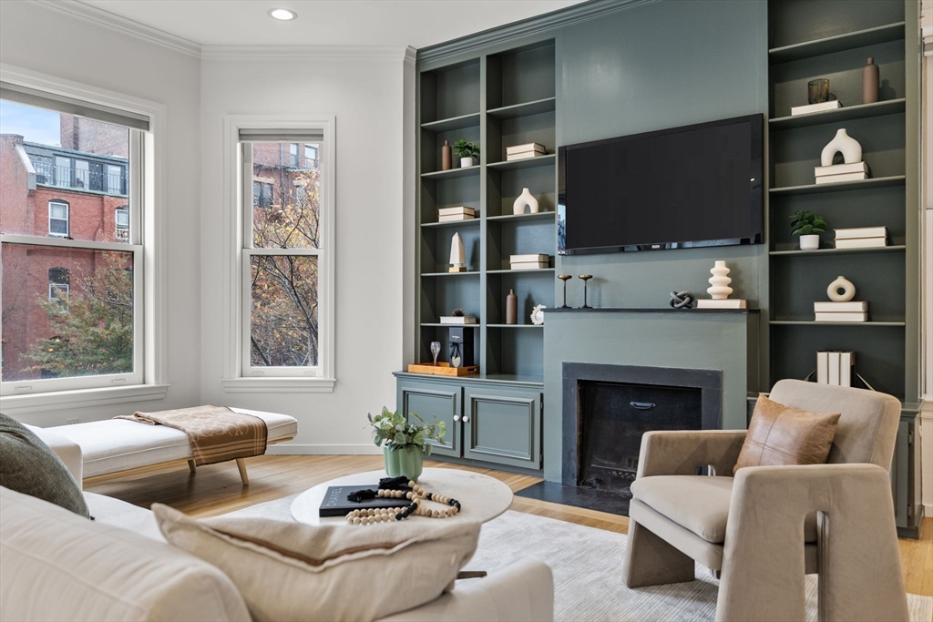 363 Marlborough Street, Unit 5 Boston, MA 02115 - Photo 4 of 23 a living room with furniture a fireplace and a flat screen tv