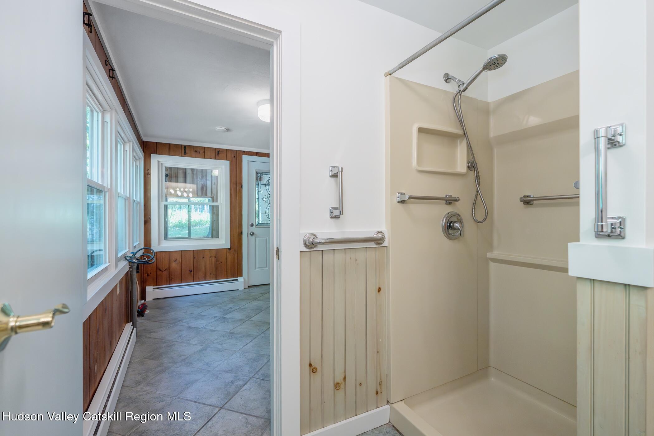 4533 Atwood Road Stone Ridge, NY 12484 - Photo 24 of 63 a bathroom with a tub shower and mirror