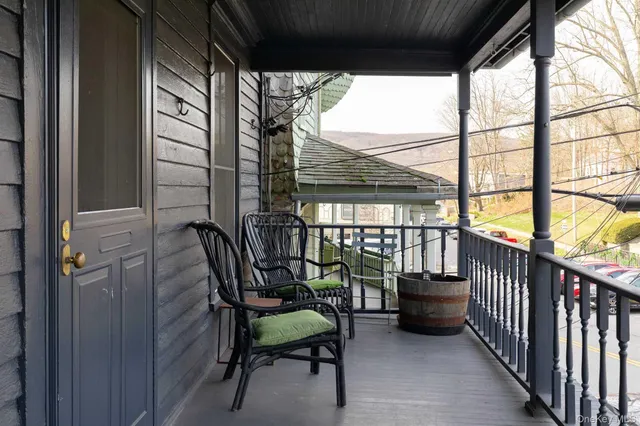 a balcony with furniture and a potted plant