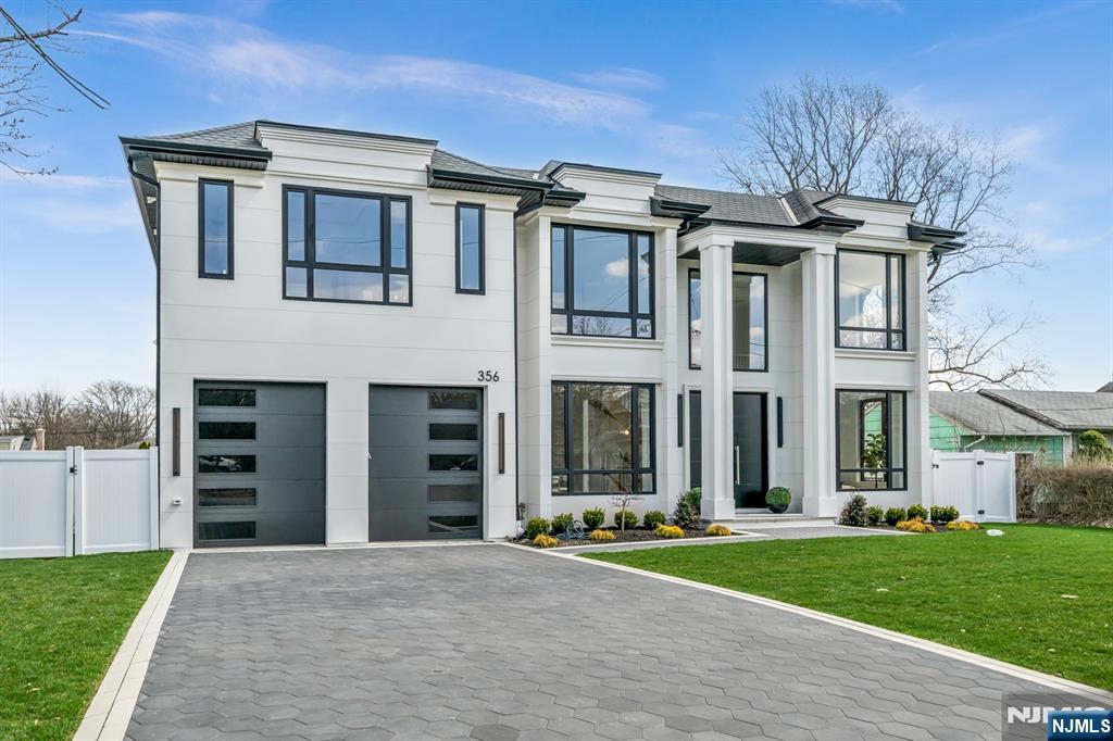 356 Bullard Avenue Paramus, NJ 07652 - Photo 2 of 50 a front view of a house with a garden and plants