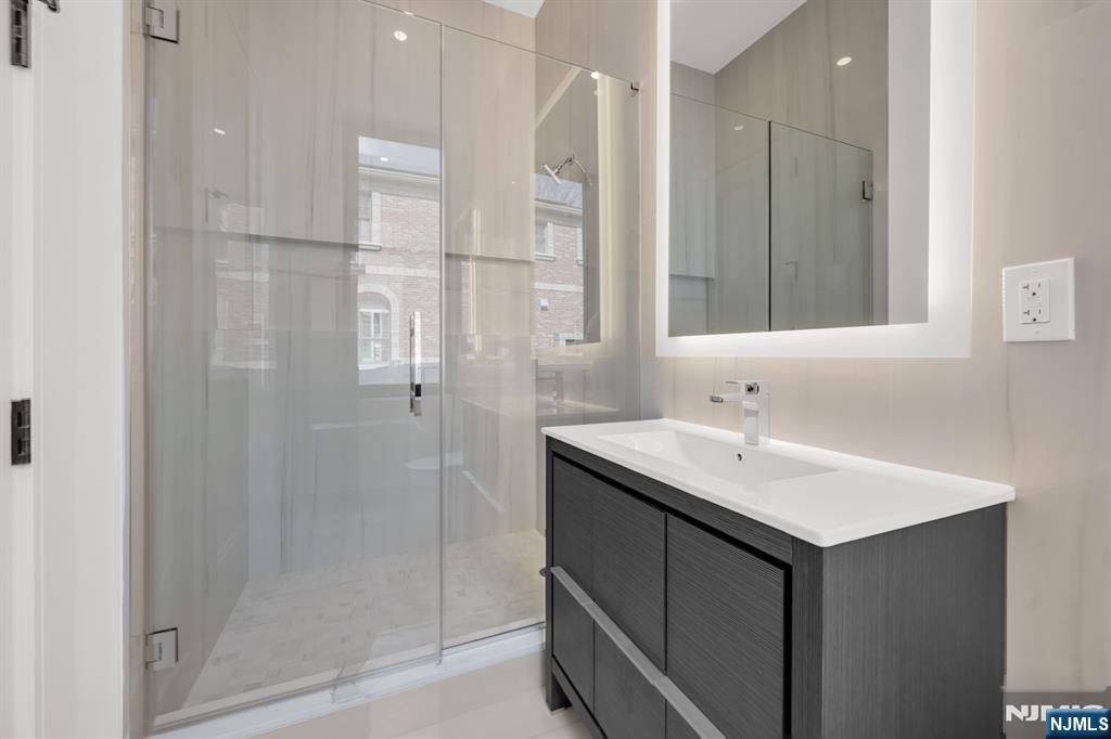356 Bullard Avenue Paramus, NJ 07652 - Photo 22 of 50 a bathroom with a sink and a mirror