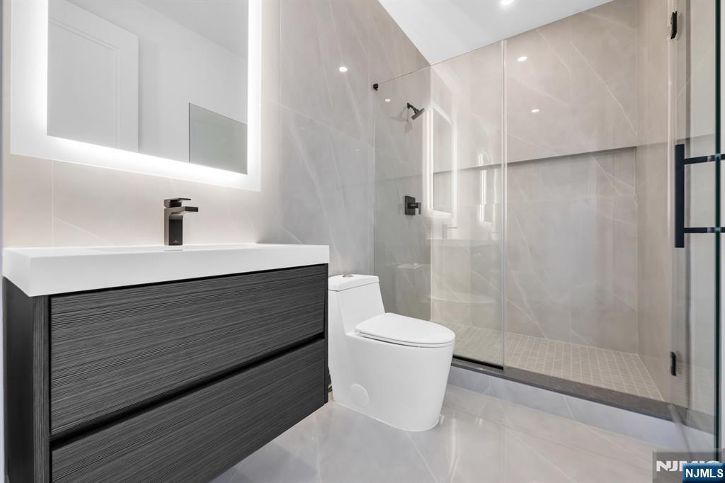 356 Bullard Avenue Paramus, NJ 07652 - Photo 39 of 50 a bathroom with a sink a toilet and shower