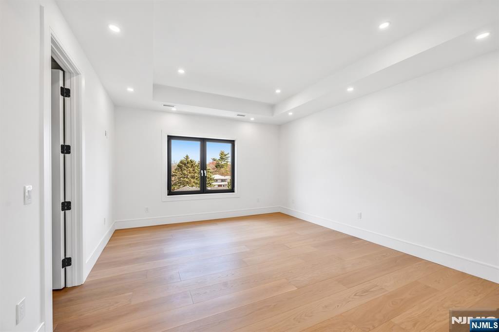 356 Bullard Avenue Paramus, NJ 07652 - Photo 40 of 50 an empty room with wooden floor and windows