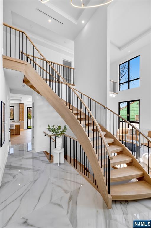 356 Bullard Avenue Paramus, NJ 07652 - Photo 4 of 50 a view of staircase with lots of frames and frames on a table
