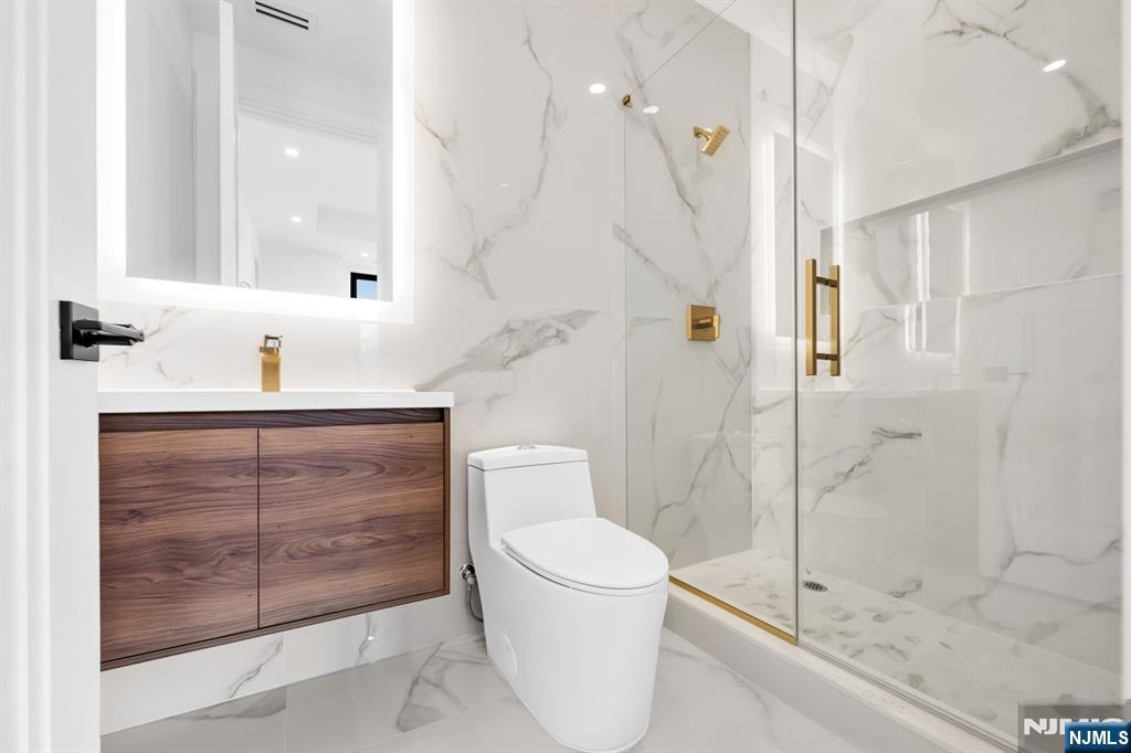 356 Bullard Avenue Paramus, NJ 07652 - Photo 41 of 50 a bathroom with a sink a toilet and shower