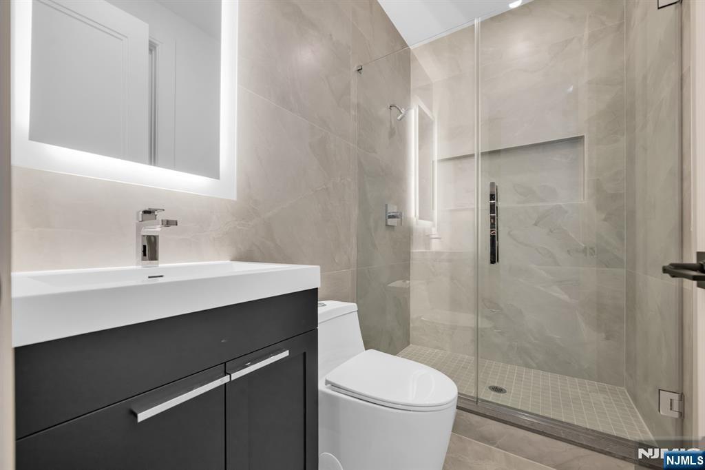 356 Bullard Avenue Paramus, NJ 07652 - Photo 47 of 50 a bathroom with a sink a toilet and shower