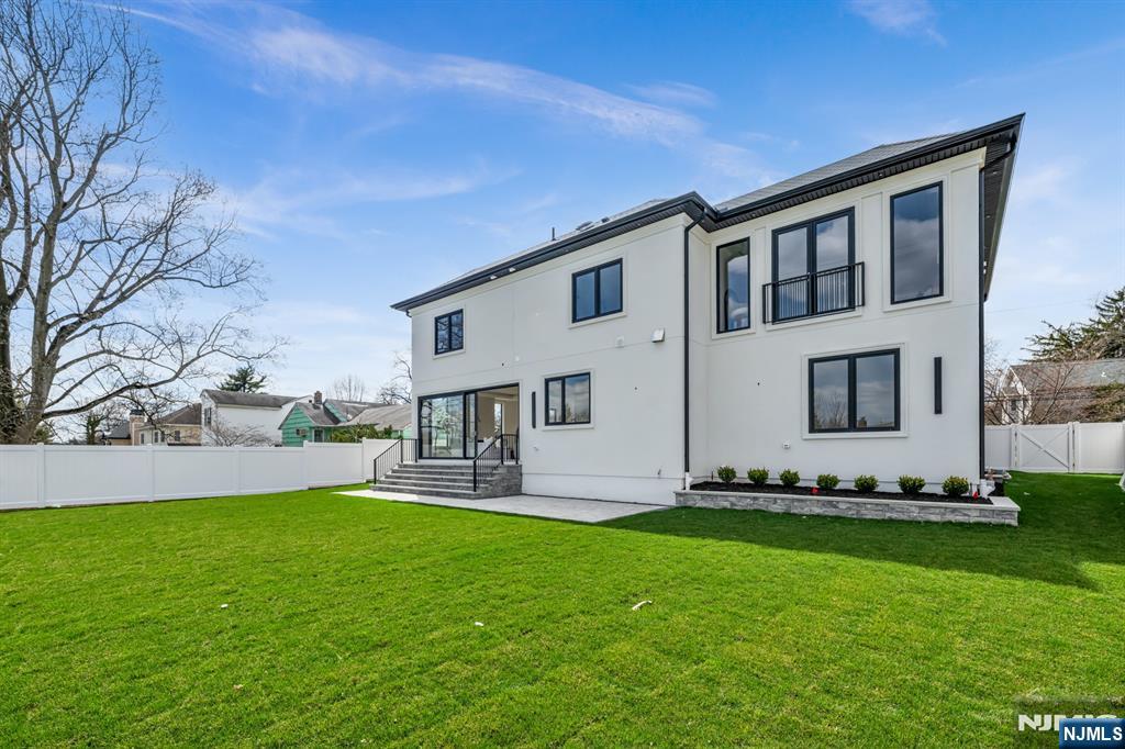 356 Bullard Avenue Paramus, NJ 07652 - Photo 49 of 50 a front view of a house with a garden and yard