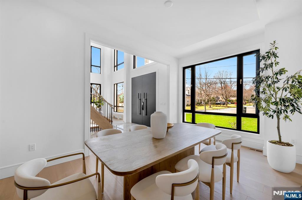 356 Bullard Avenue Paramus, NJ 07652 - Photo 6 of 50 a view of a dining room with furniture a chandelier and wooden floor